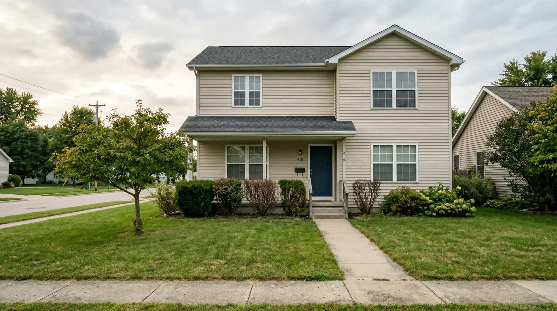 Original front yard before AI landscape redesign showing basic lawn and sparse plantings