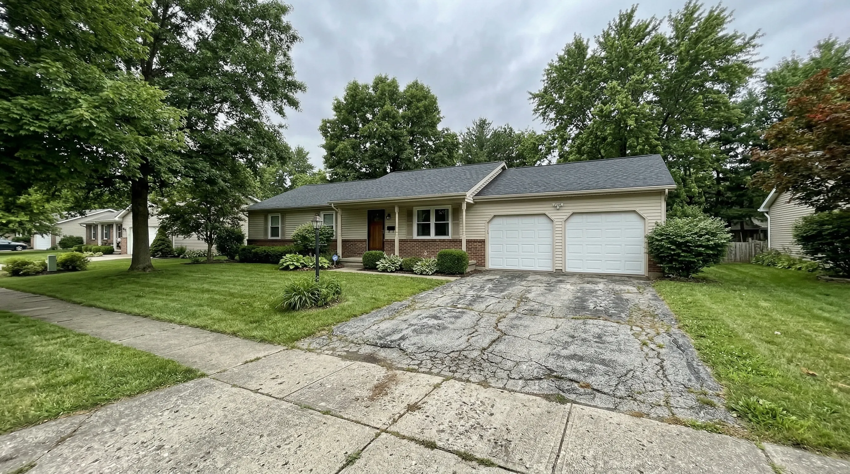 Original home with its worn concrete driveway